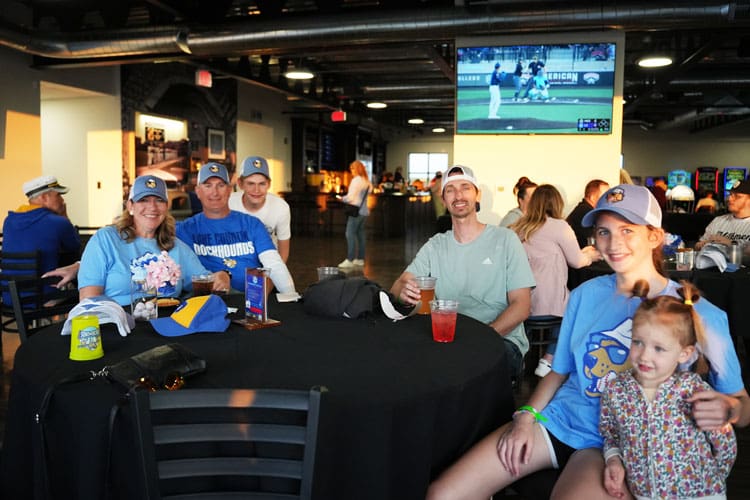 A family enjoying the Baird Wealth Management Club level during a DockHounds game