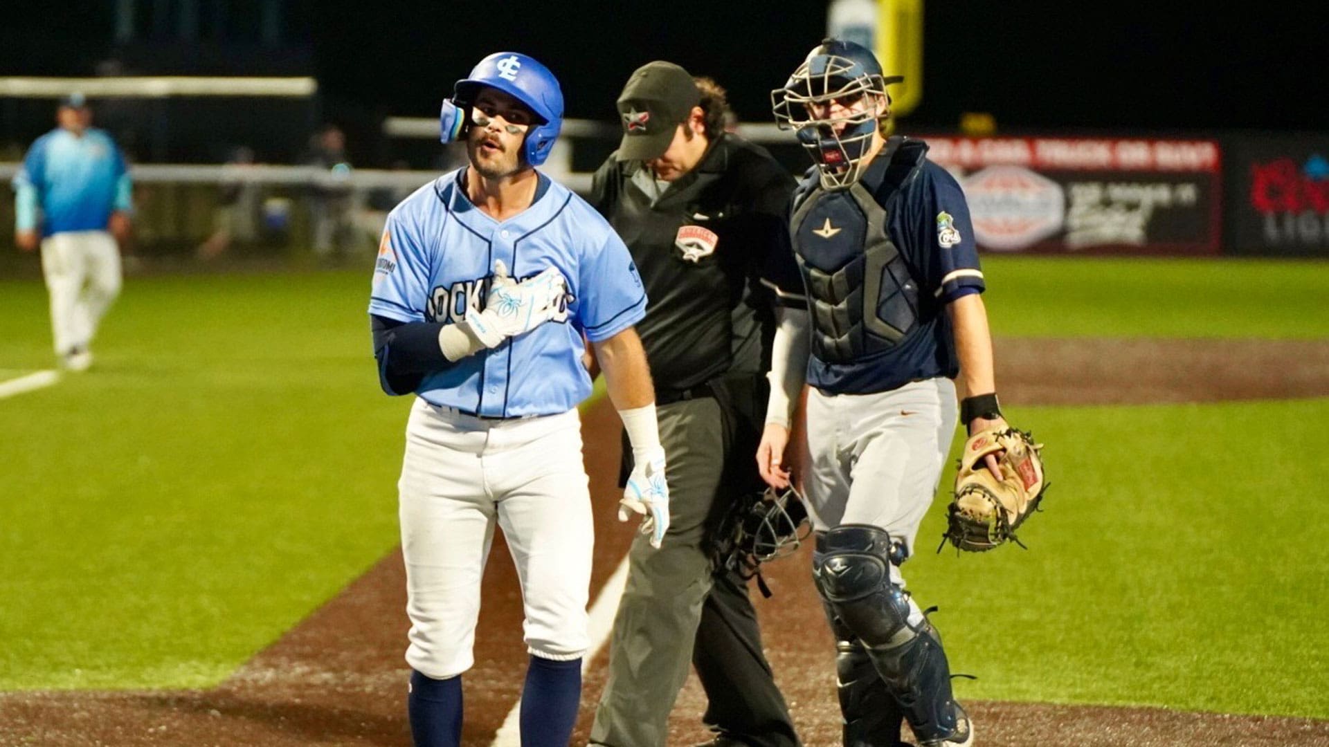 Ray Zuberer celebrates at home after a home run helps boost the Hounds to a win over the Cougars