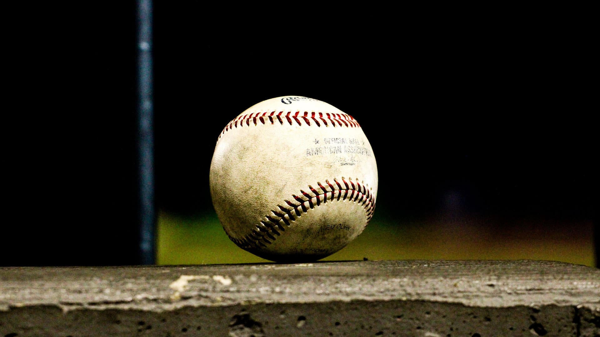 Baseball sitting on the ledge of the dugout at WBC Park